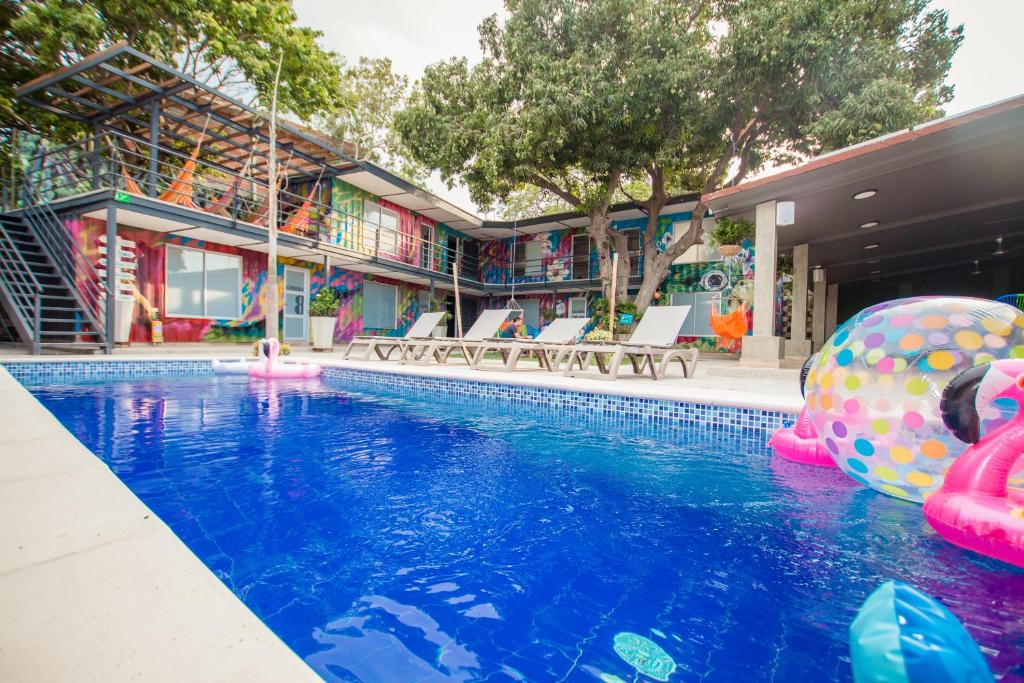 a swimming pool with an inflatable ball in the water at Casa Avelina Boutique Hostel in Santa Marta
