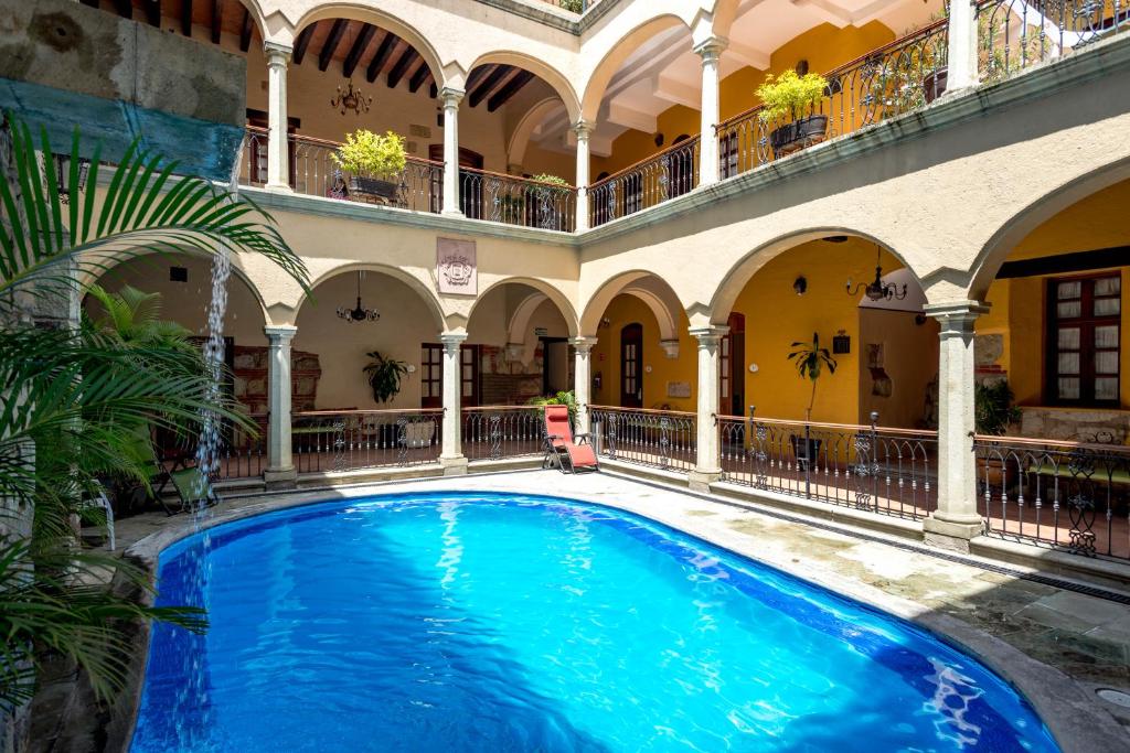 
a large swimming pool in a large building at Hotel CasAntica in Oaxaca City
