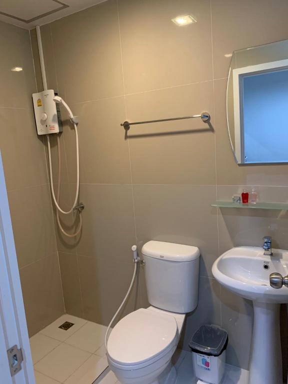 
a bathroom with a toilet a sink and a shower at 9TY hotel (ninety hotel) in Bangkok
