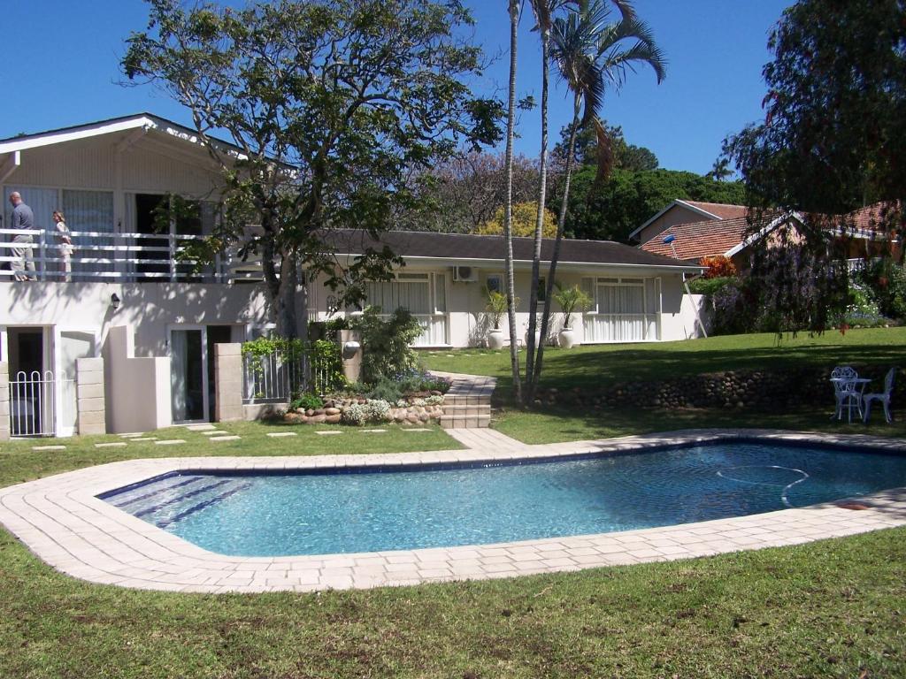 a swimming pool in the yard of a house at Avillahouse Guesthouse in Durban
