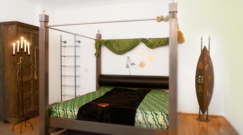 a bedroom with a canopy bed in a room at Bon-Apart in Görlitz