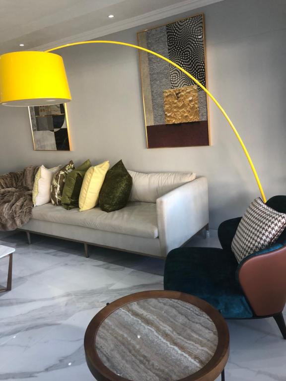 a living room with a couch and a table at 44 La Pirogue in Ballito