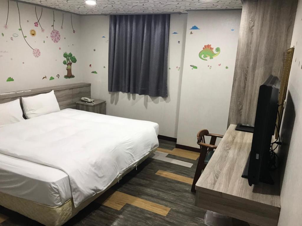 &#x5FC3;&#x5712;&#x751F;&#x6D3B;&#x65C5;&#x5E97; Xin Yuan Hotel&#x623F;&#x9593;&#x7684;&#x5E8A;