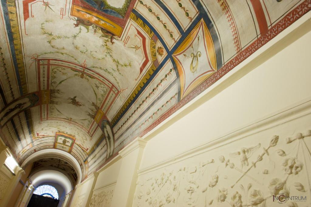 a room with paintings on the ceilings of a building at Incentrum in Rome