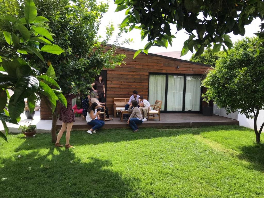 a group of people sitting on the deck of a house at Casa do Muro in Coimbra