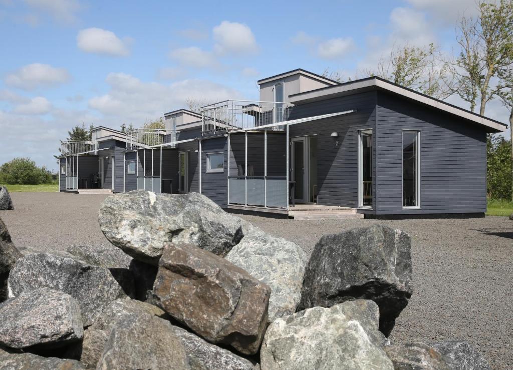 a row of houses with rocks in front of them at Tangsø Hytteby in Bækmarksbro