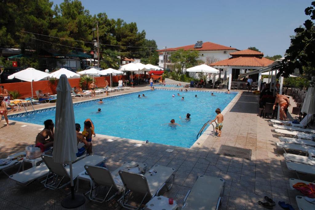 a large swimming pool with people in it at Hotel Camping Agiannis in Makrygialos