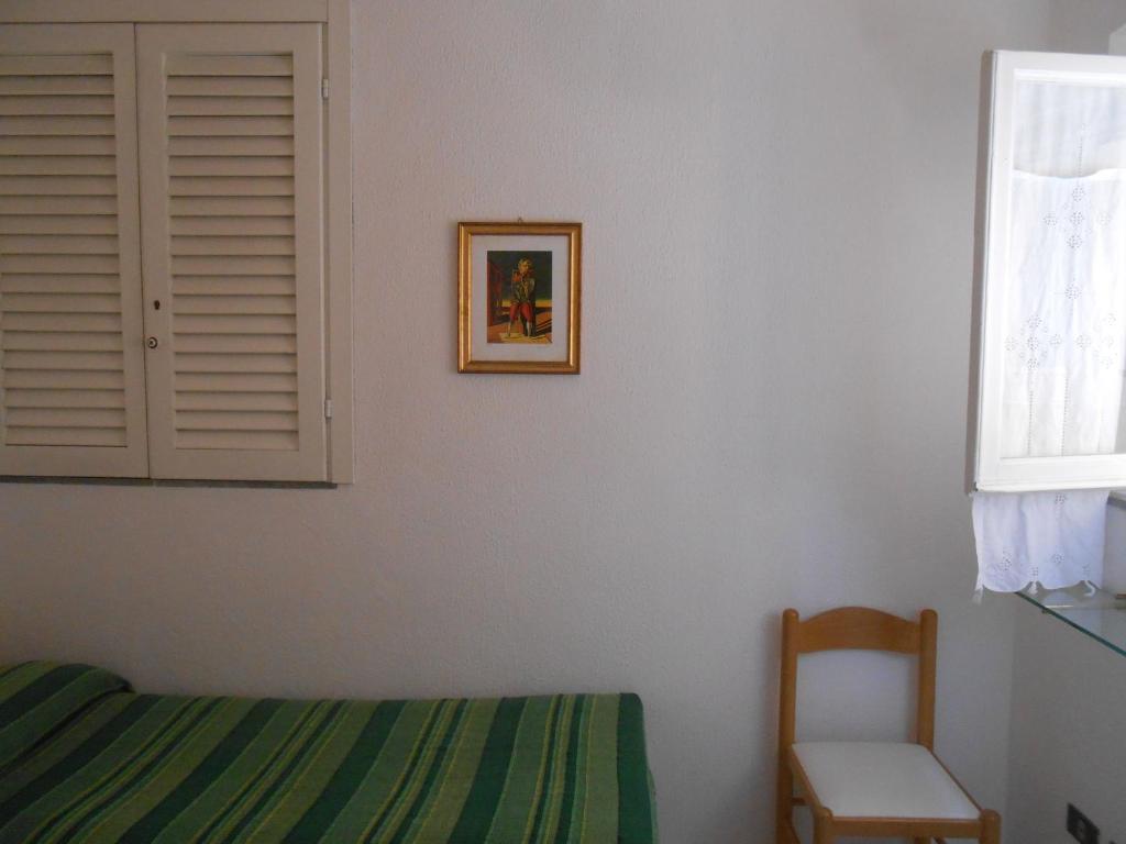 Postel nebo postele na pokoji v ubytování PENSIONE VERDE LUNA