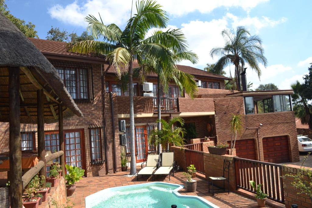 an exterior view of a house with a swimming pool at Edelweiss Corporate Guest House in Pretoria