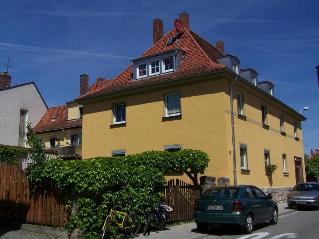 a large yellow house with a red roof at Ferienwohnung Heinrichseck in Bamberg