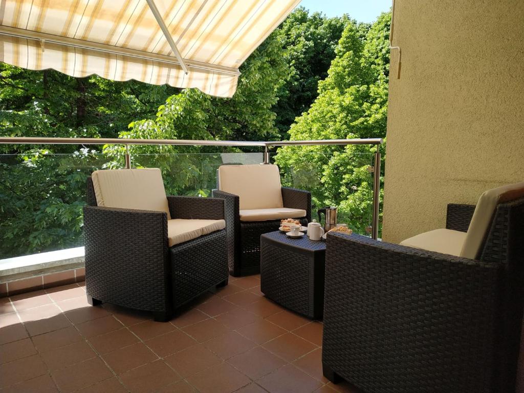 a patio with chairs and a table and a window at Appartment Trojer in Merano