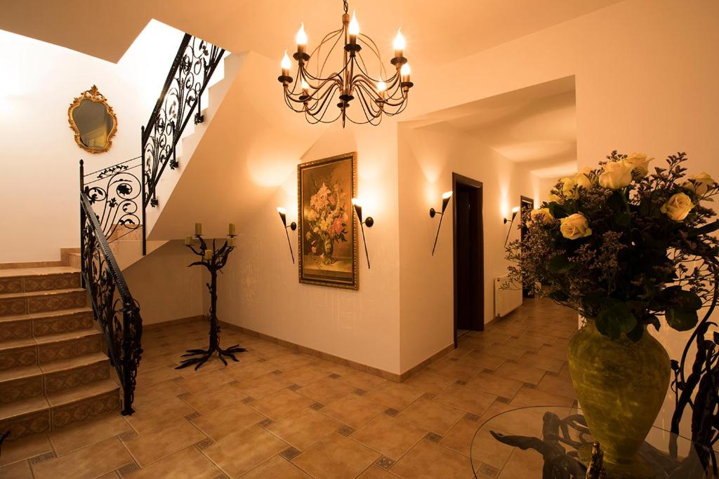 a hallway with a vase of flowers and a chandelier at Residenz Selena in Ustka