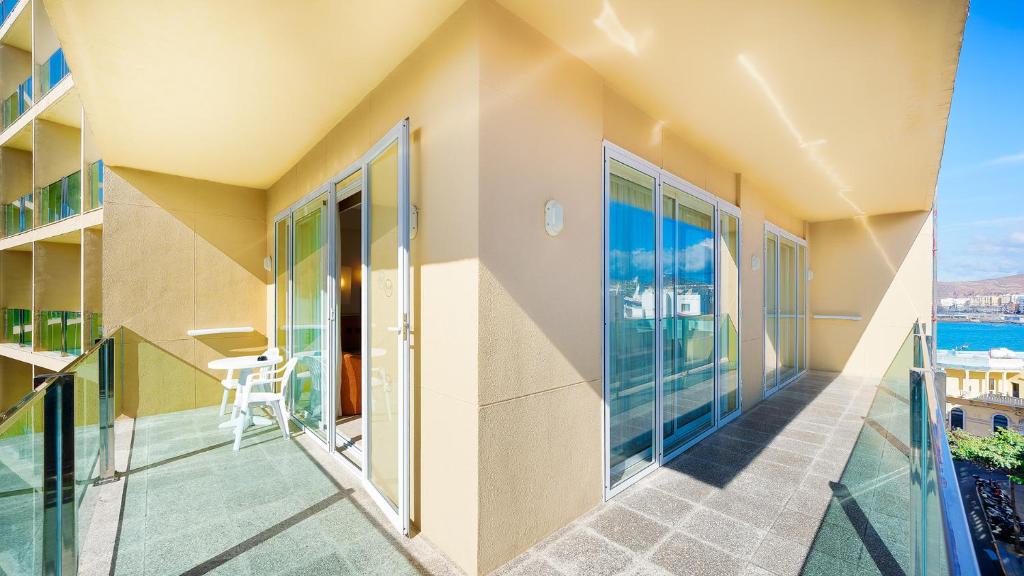 a balcony of a house with a view of the ocean at Bull Reina Isabel & SPA in Las Palmas de Gran Canaria