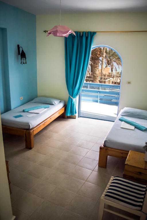 Postel nebo postele na pokoji v ubytování El Primo Hotel Dahab