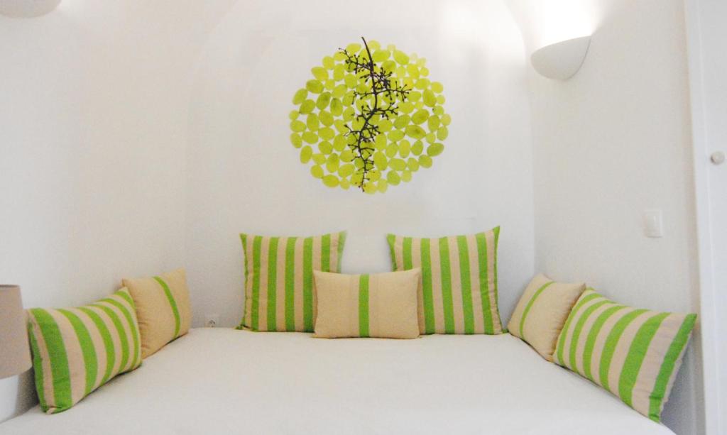 A bed or beds in a room at White Grape Suites