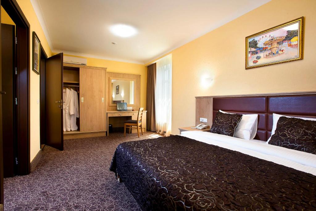 A bed or beds in a room at GRAND OTRADA Hotel Resort & SPA