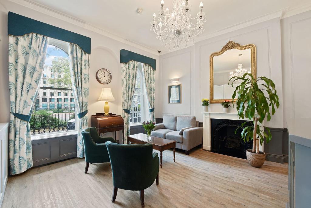 a living room with a couch and a fireplace at The Judd Hotel in London