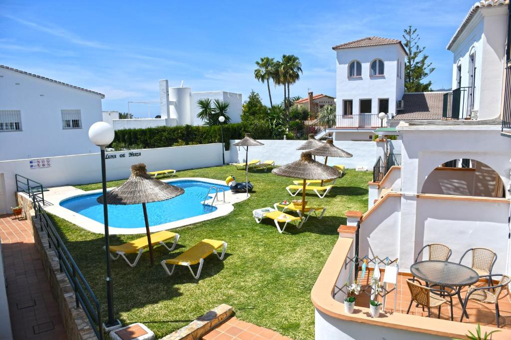 an image of a backyard with a swimming pool and patio furniture at Luna de Nerja in Nerja