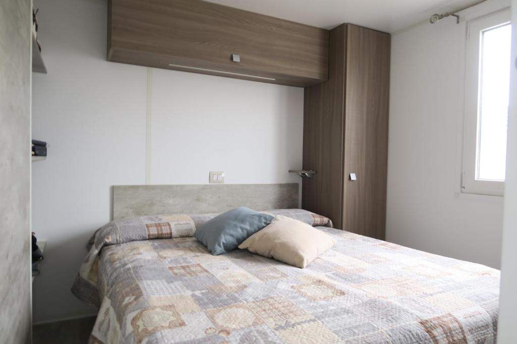 A bed or beds in a room at Camping Adriatico