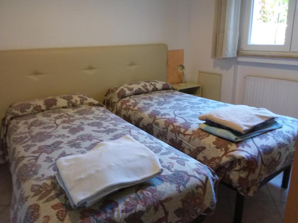 Postel nebo postele na pokoji v ubytování Residence Cascata Varone