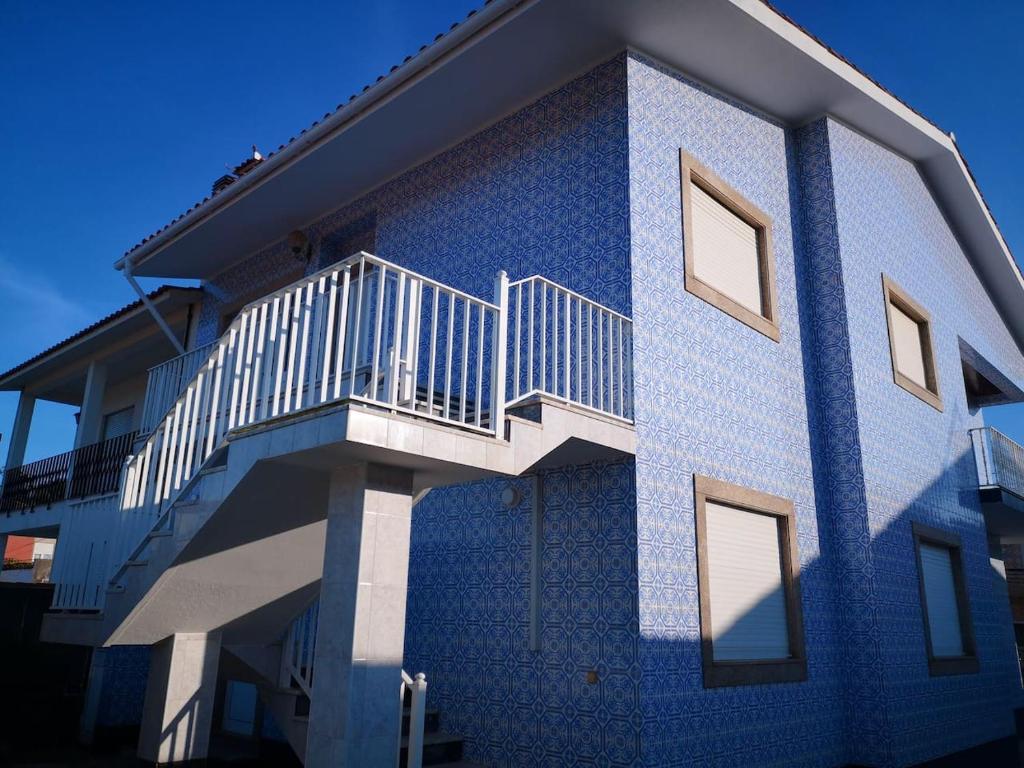 a blue building with a staircase on the side of it at Blue Tex in Vila Chã