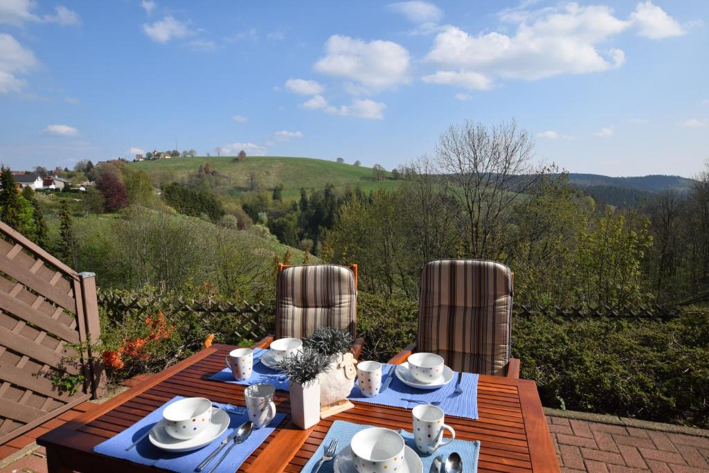 a wooden table with blue and white dishes on it at Ferienwohnung HEXE mit Komfort **** in Sankt Andreasberg