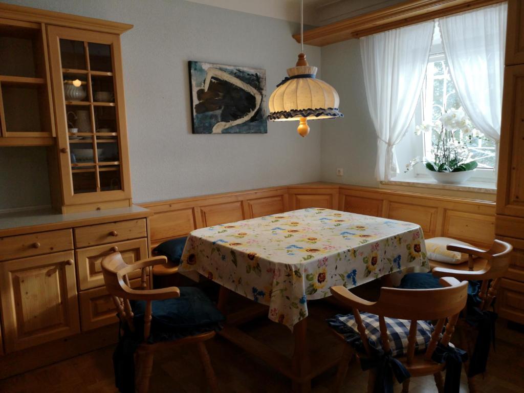 a kitchen with a table and chairs and a table and a window at Apartment (3 Gerste) in Hargelsberg