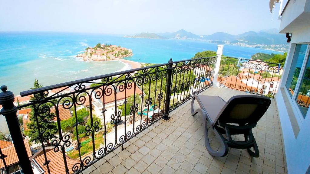 a balcony with a table and a view of the ocean at Villa Edelweiss in Sveti Stefan