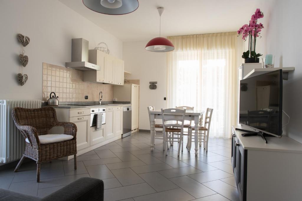 a kitchen and dining room with a table and chairs at Luisella Apartments in Albenga