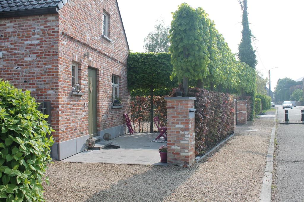 a brick building with a tree on the side of it at L'enjo'Leuze in Winée