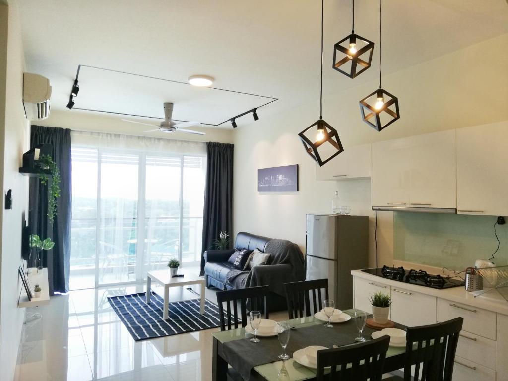 a kitchen and living room with a table and chairs at Ara Damansara Oasis Residence, Specious Home 4-8pax, 8min Subang Airport, 10min Sunway in Petaling Jaya
