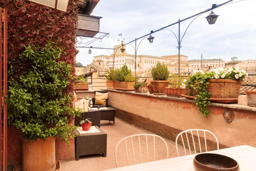 a balcony with tables and chairs and plants at Principessa Trevi in Rome