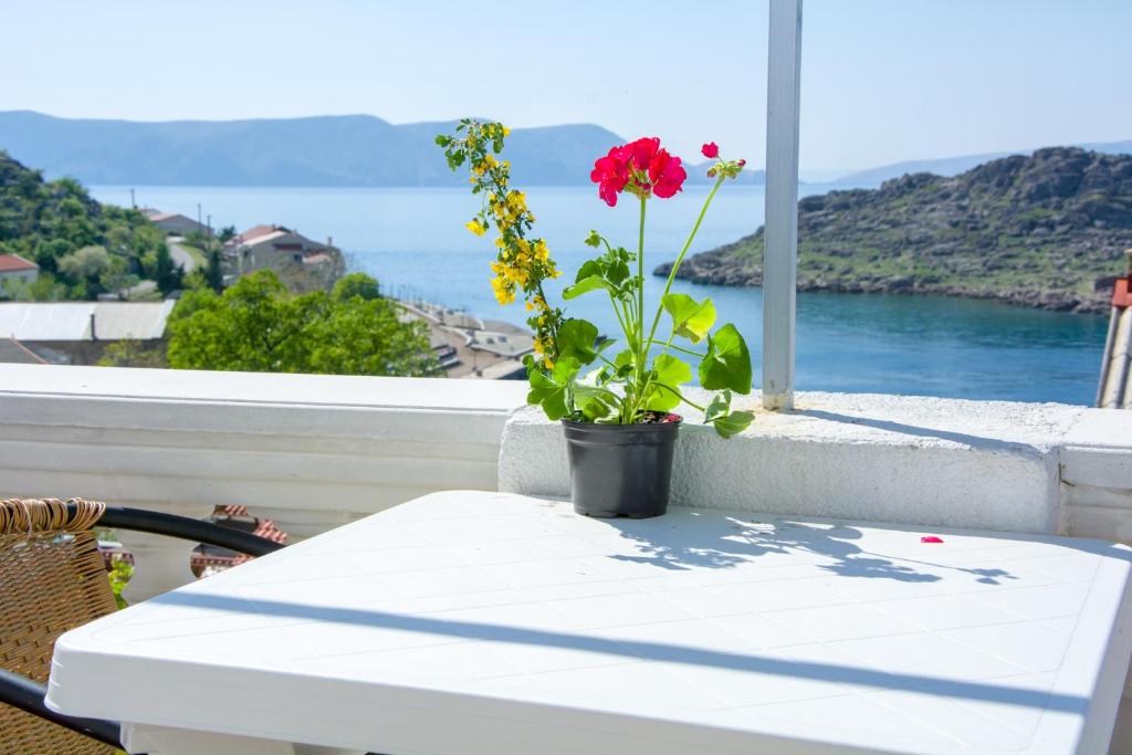 eine Blume in einem Topf auf einem Tisch auf einem Balkon in der Unterkunft Apartment Kata in Sveti Juraj