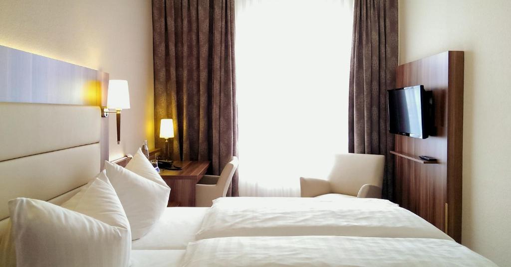 Postel nebo postele na pokoji v ubytování Hotel Burgas