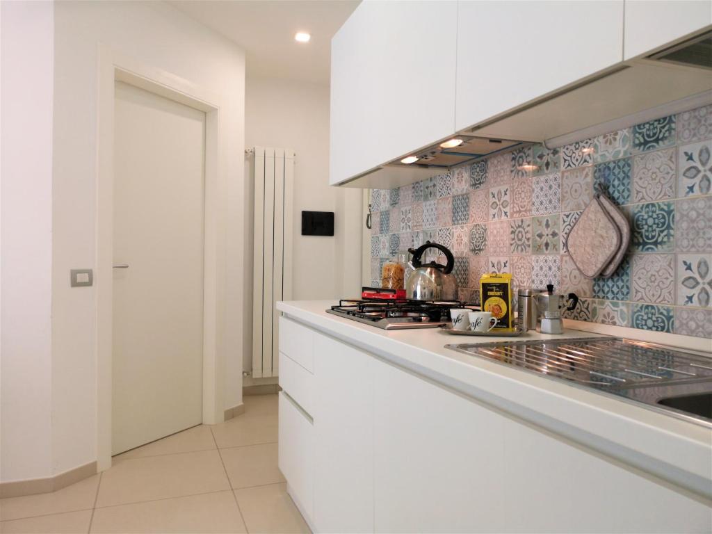 a kitchen with a white counter top and a stove at Caponapoli 8 in Naples