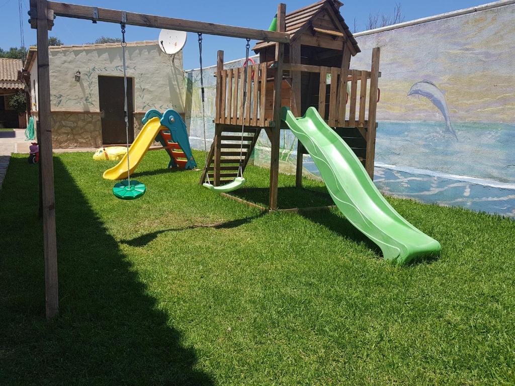a playground with a slide and a play house at Residencial La Teja in Zahora