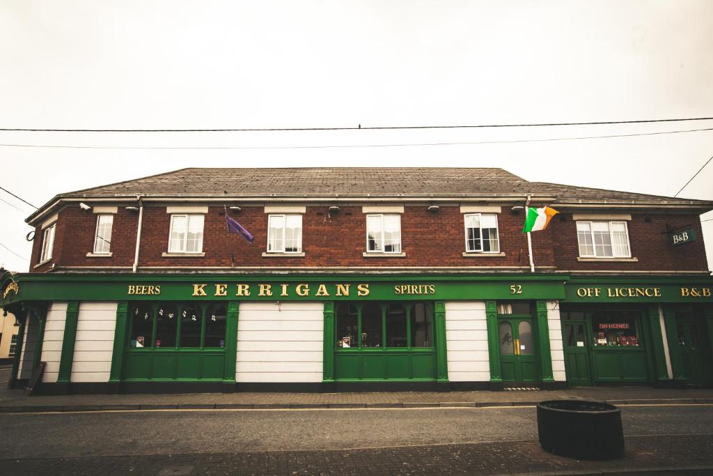 a building with green and white doors on a street at Kerrigan's B&B in Mullingar