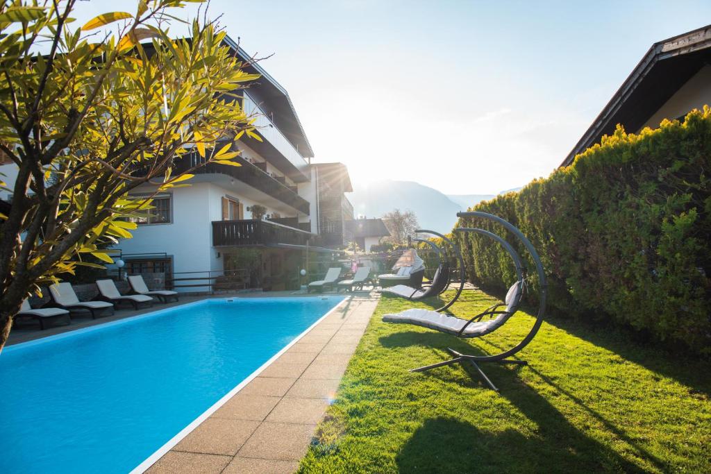 a swimming pool in the yard of a house at Hotel Turmwies in Tirolo