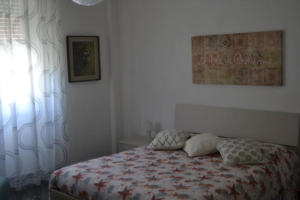 a bedroom with a bed and a window at Cà da Lalla Maria in Noli