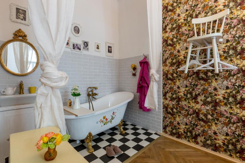 a bathroom with a tub and a sink at Vintage Home in the Center in Budapest