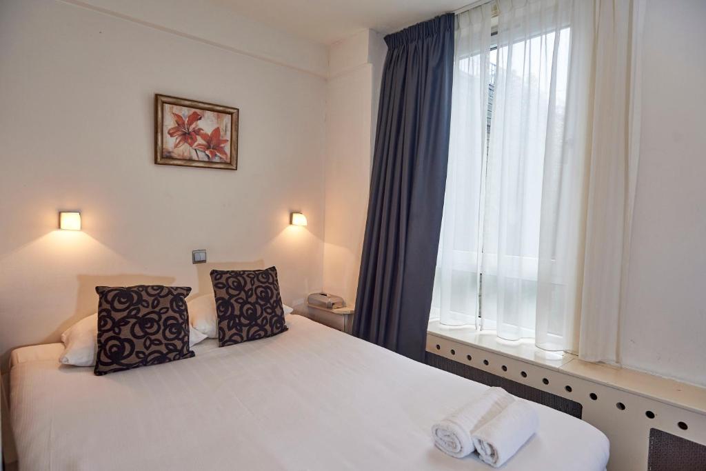 Postel nebo postele na pokoji v ubytování ITC Hotel