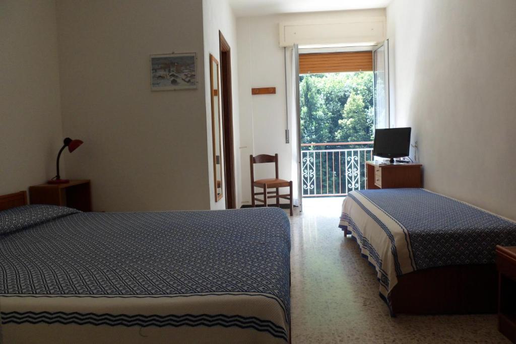 Postel nebo postele na pokoji v ubytování Albergo Ristorante Regina