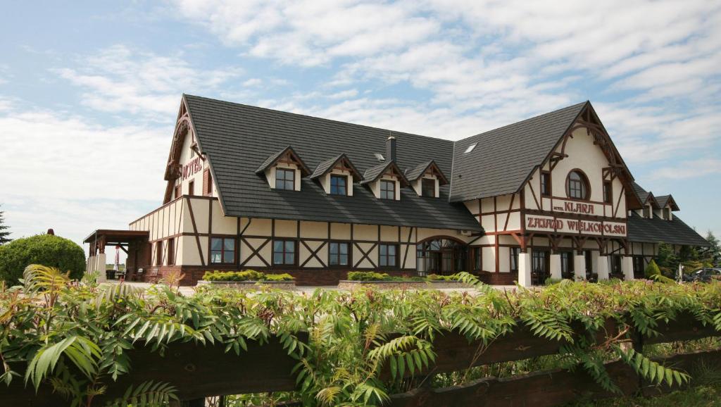 a large house with a black roof at Motel Klara in Sobótka