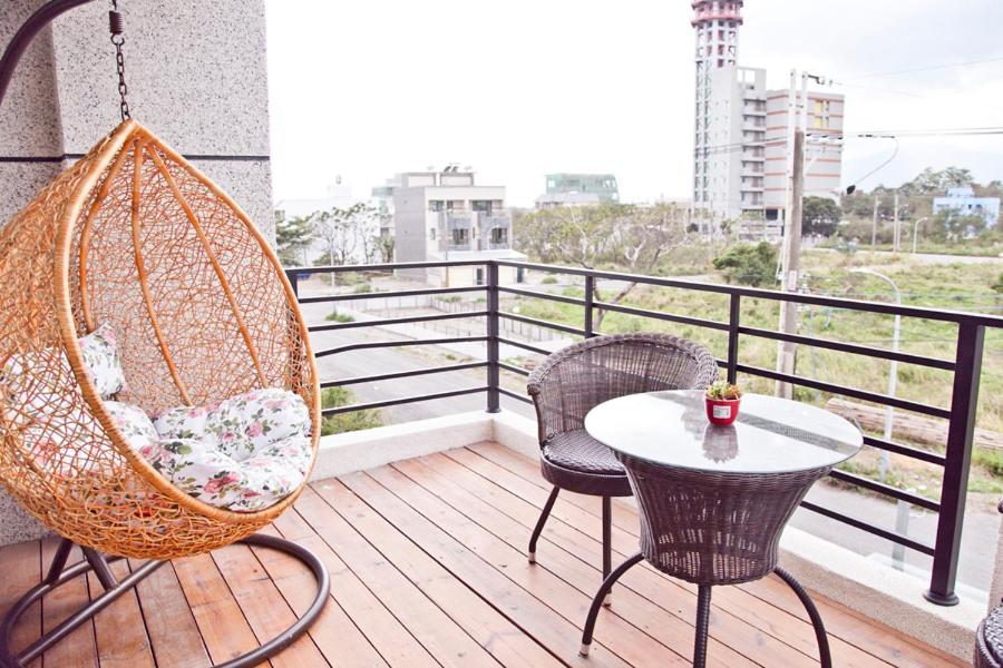 a balcony with two chairs and a table on a porch at Antlers Guest House in Taitung City