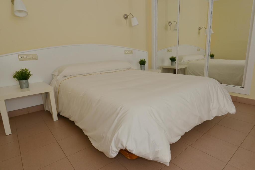 A bed or beds in a room at Apartamentos Marina