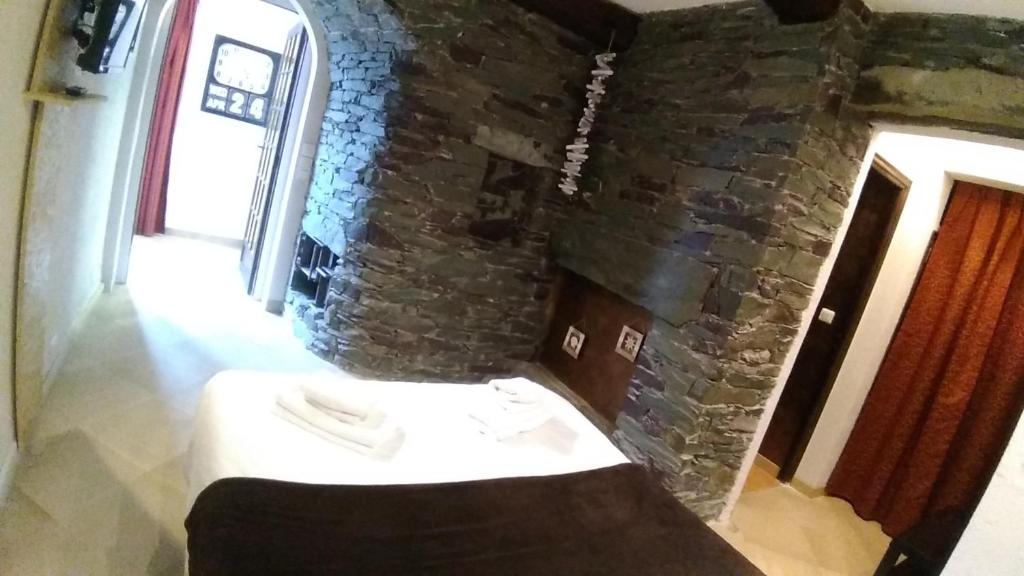 a room with a brick wall and a table in a room at Villa Azur Cap d'Ail in Cap d'Ail