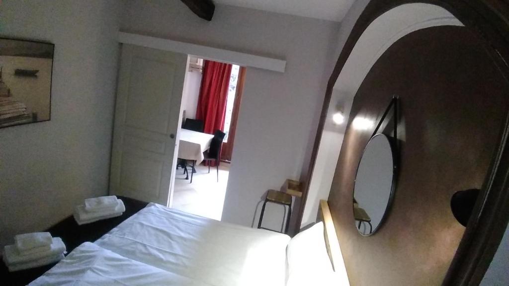 a hotel room with a bed and a mirror at Villa Azur Cap d'Ail in Cap d'Ail