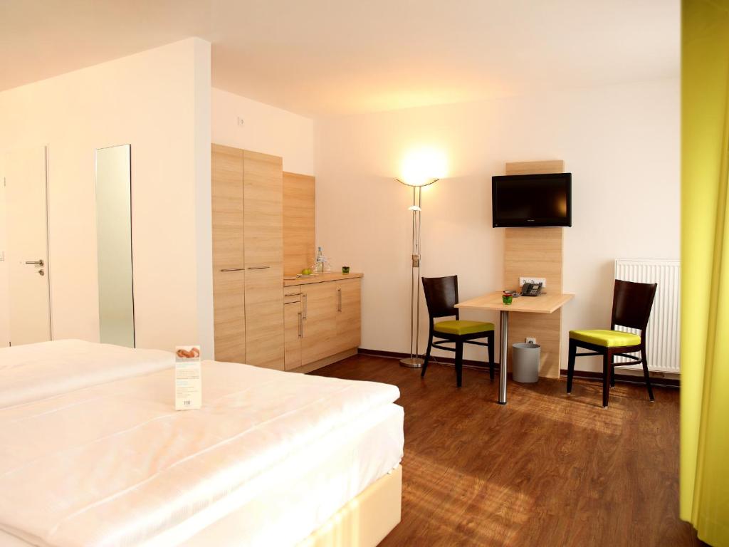Postel nebo postele na pokoji v ubytování ante porta DAS STADTHOTEL