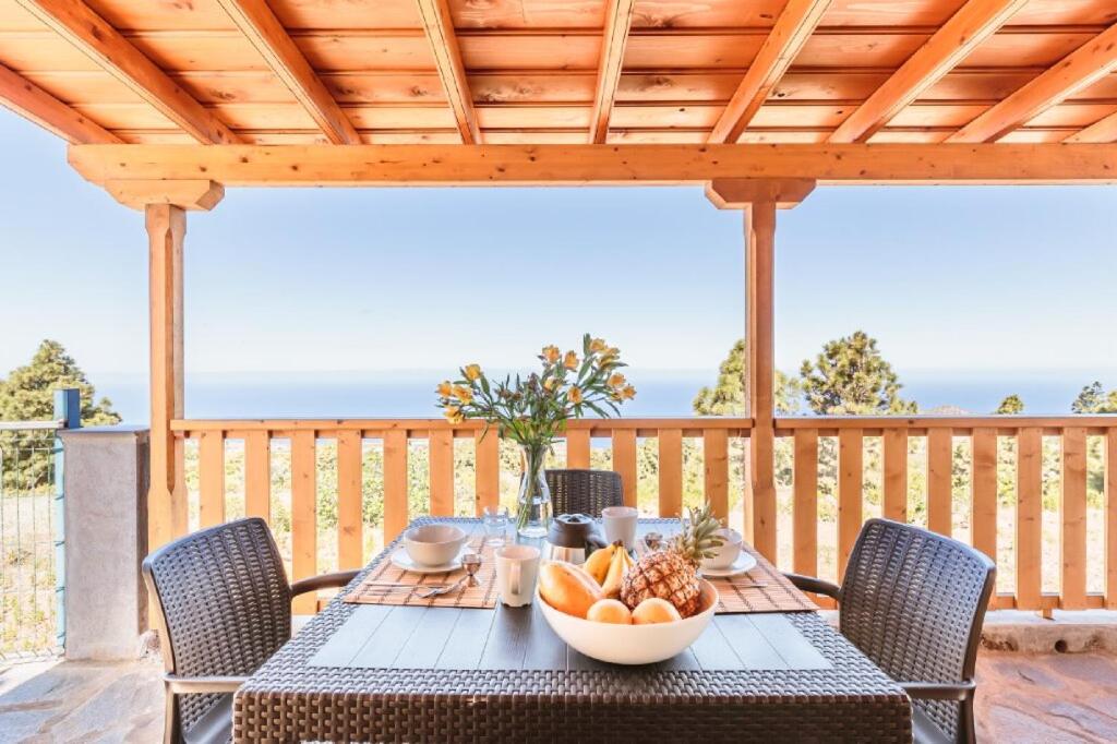 a table with a bowl of fruit on a deck at CASA LAURA el canal in Puntagorda