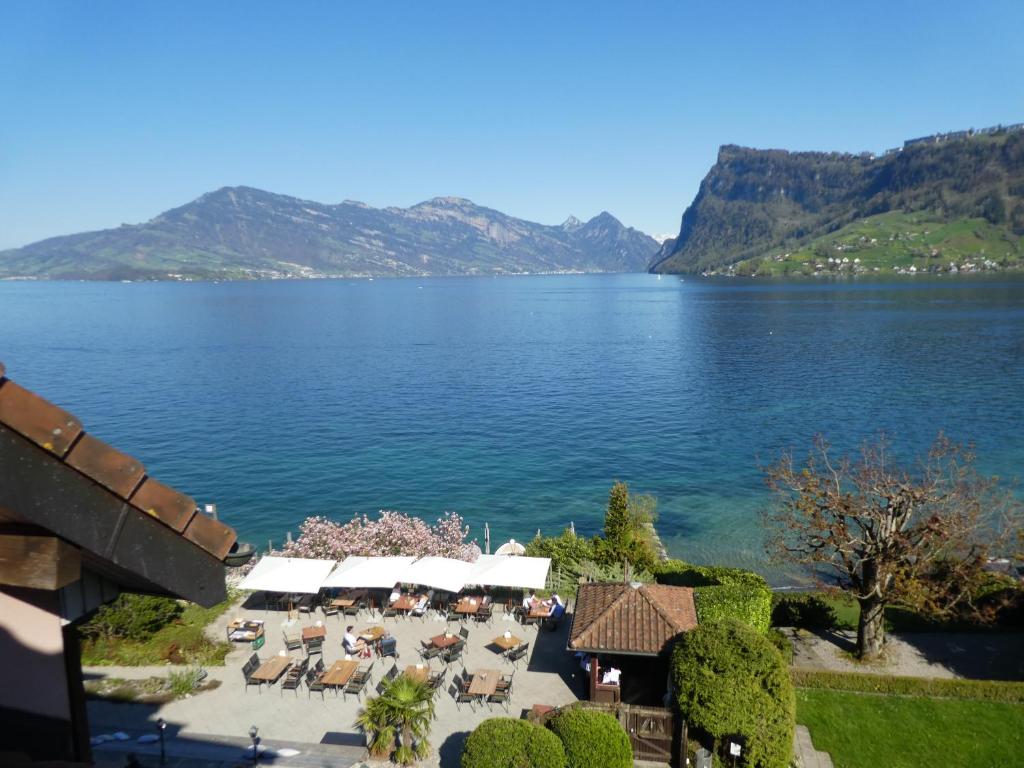 an aerial view of a lake with tables and chairs at Residence Kastanienbaum in Lucerne